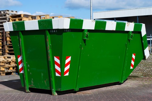 Front view of a commercial waste vehicle operating in an urban Colindale street